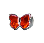 Load image into Gallery viewer, A sterling silver ring with a red orange quartz butterfly design on a sandy background.