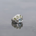 SilverMelt sterling silver ring with blue topaz and peridot crystals in an eye design.