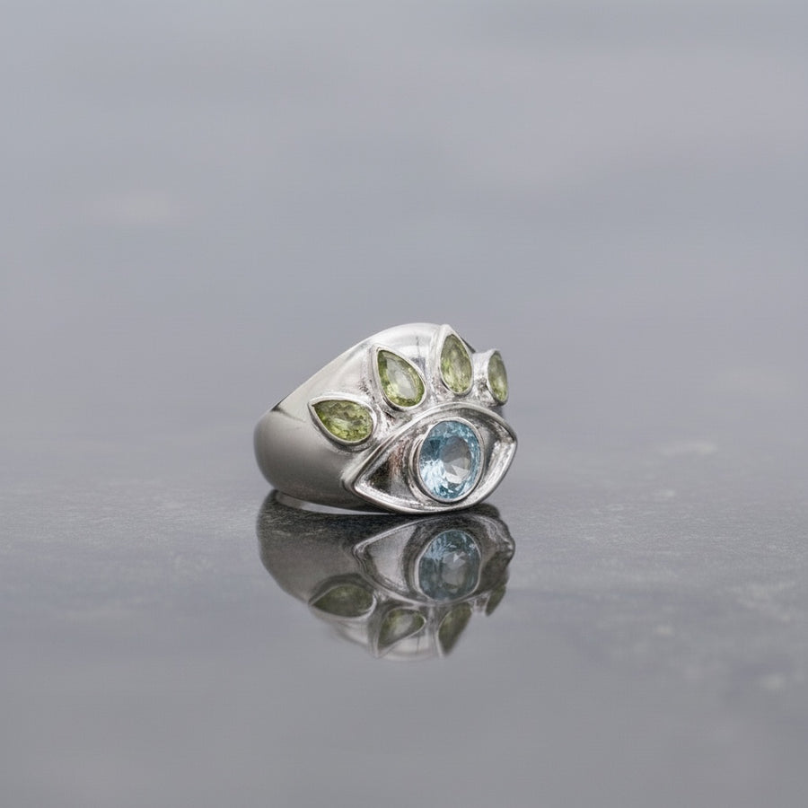 SilverMelt sterling silver ring with blue topaz and peridot crystals in an eye design.