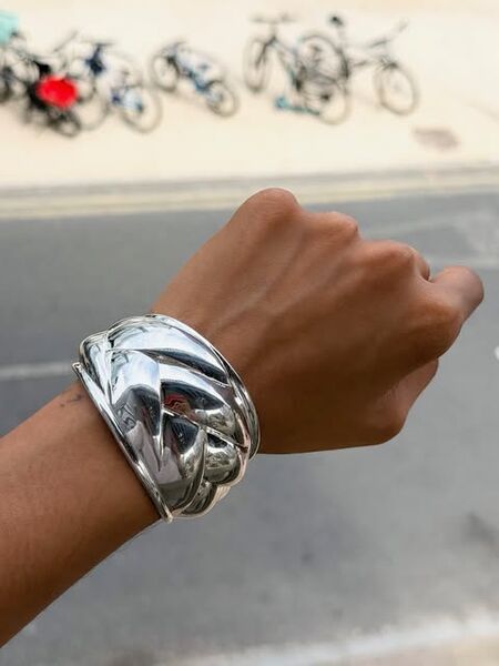 A silver cuff worn on the street