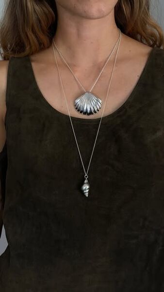 The shell and conch necklaces layered